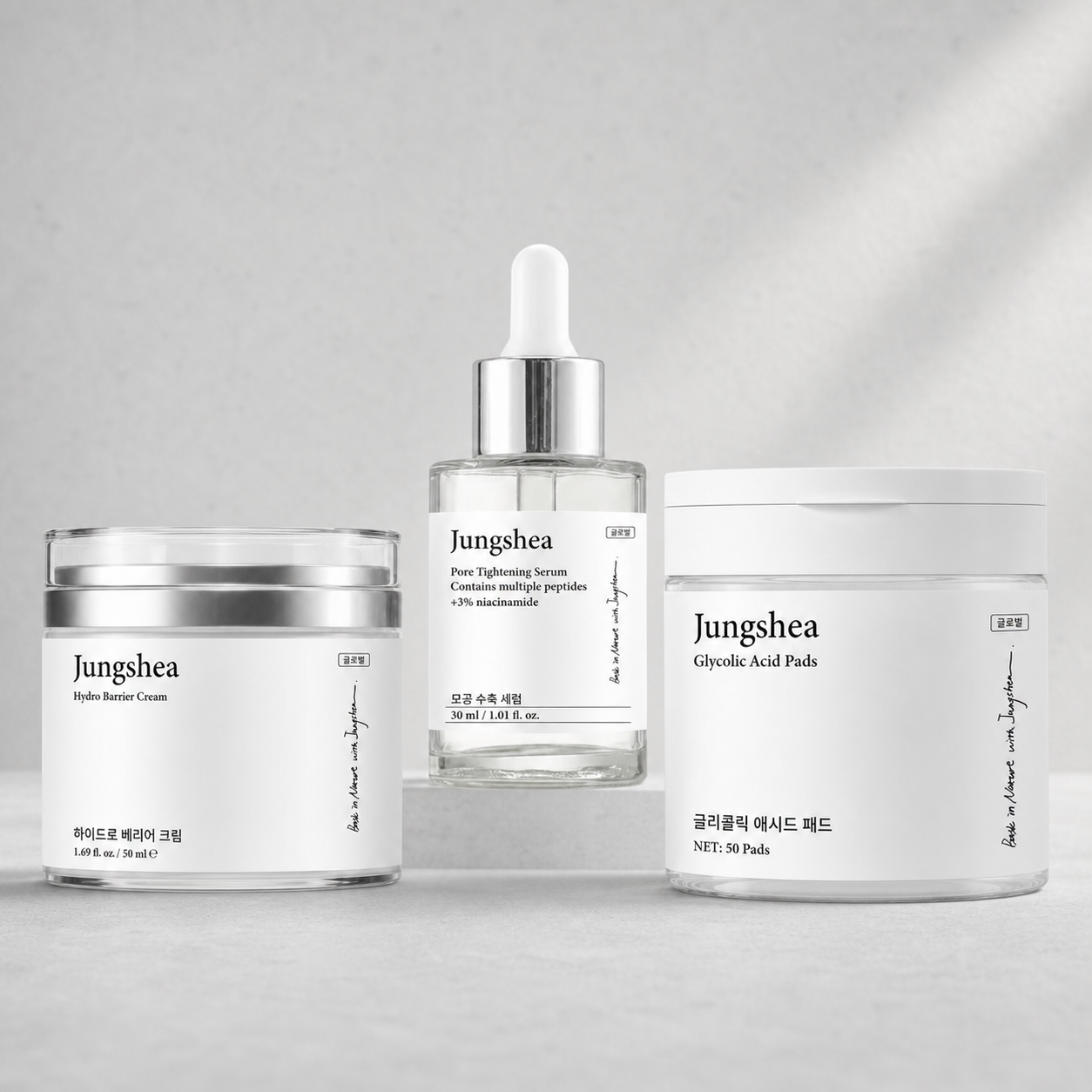 Jungshea serum, barrier cream, and glycolic acid pads arranged together on a light gray background