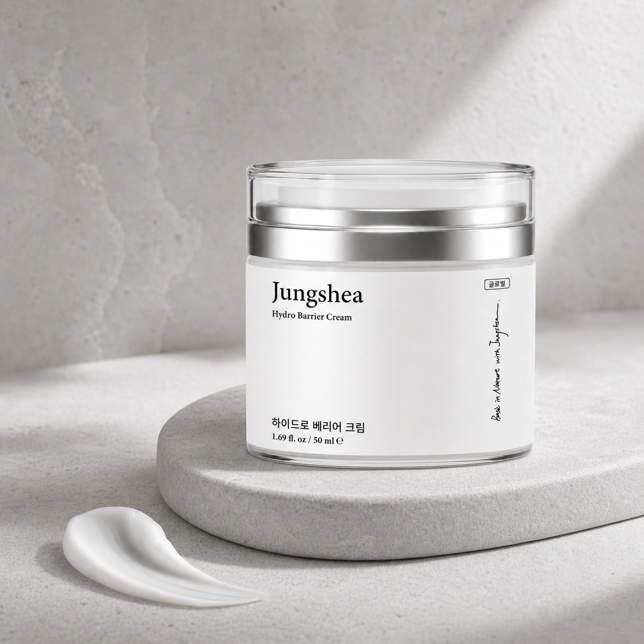 Jungshea moisturizer jar on a gray stone pedestal with a swipe of white cream